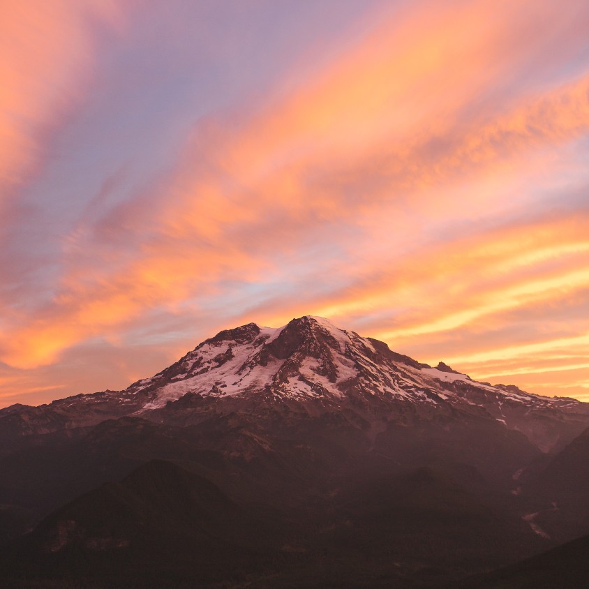 picture of a mountain in front of a pink sky